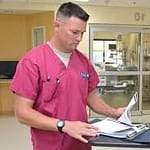 Guy nurse in pink scrub suit